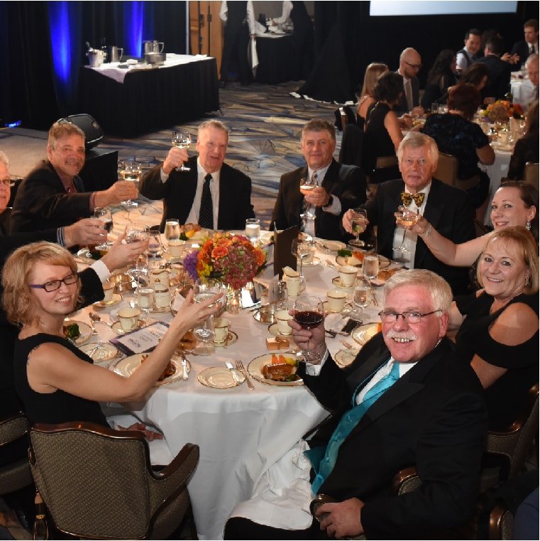 A table full of people enjoying dinner and drinks at the Salute BC 2017 Gala